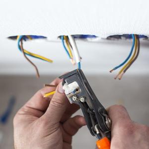 electrician wiring a socket in Cambridgeshire